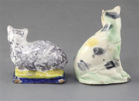 A Whieldon type creamware figure of a cat, c.1780 and a tinglaze figure cat on a cushion, possibly 18th century, tallest 8cm